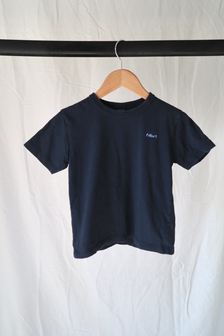 Next UK navy cotton tee on a wooden hanger against a white backdrop